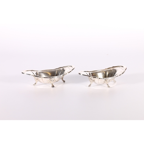 38 - Pair of Victorian silver dishes of oblong boat shape raised on four splayed feet by David Crich... 