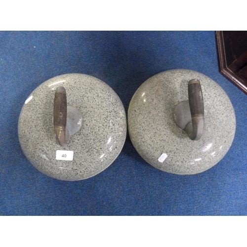 40 - Pair of polished curling stones with wood and metal handles.