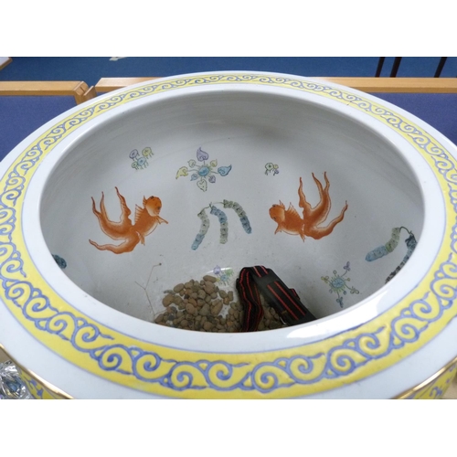 11 - Modern Chinese pottery fish bowl with floral decoration on yellow ground, on stand.