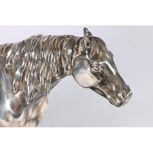 267 - Silver filled figure of a horse, raised on an ebonised wooden plinth, 19cm tall, overall 31cm.