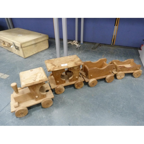 28 - Wooden train comprising a locomotive, tender and two wagons.  (4)