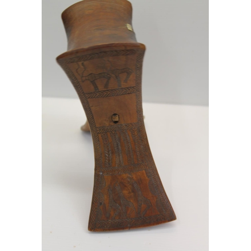 37 - Unusual African neck rest, having two splayed supports decorated with animal carvings, 20cm high.