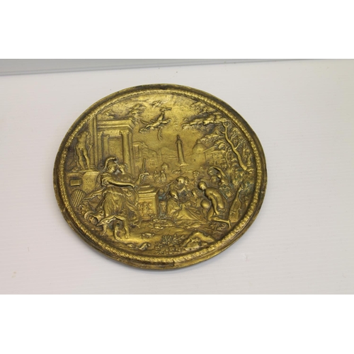 59 - Brass plaque depicting Roman scene, 15cm diameter.