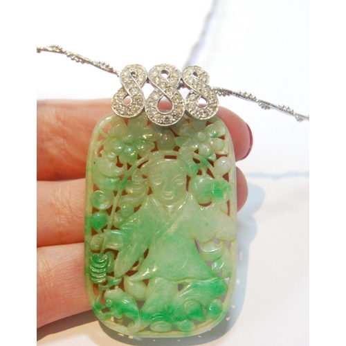 22 - Jadeite pendant, rounded rectangular, with pierced and carved figure and sprays, upon diamond-set wh... 