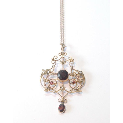 36 - Edwardian garnet and pearl openwork pendant, in gold, '9ct', 7.2g.
