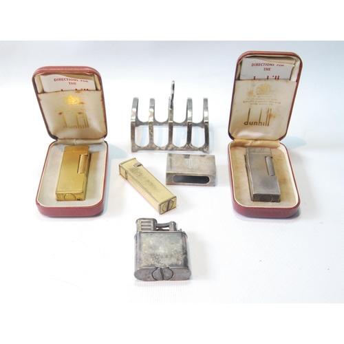 44 - Dunhill EP storm lighter, 1940s, and another, engine turned, with case, two rolled gold lighters, on... 