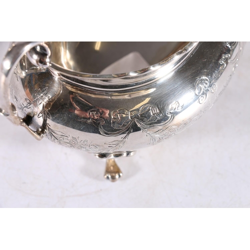 12 - George V sterling silver four piece tea service, with ribbon and garland decorated body, raised on p... 