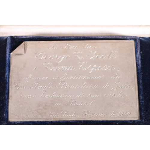 25 - Boxed silver panel to George E Scott regarding a trip to brail, dated 1960, 51g.