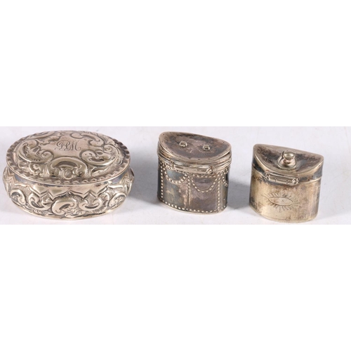 44 - Two antique silver hinged pill boxes of cylindrical form, one engraved to the base DRB and a repouss... 