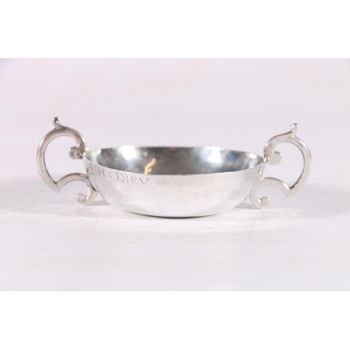 53 - Antique French silver twin handled taste vin, the rim stamped H.Diev, 10cm, 37.7 grams.