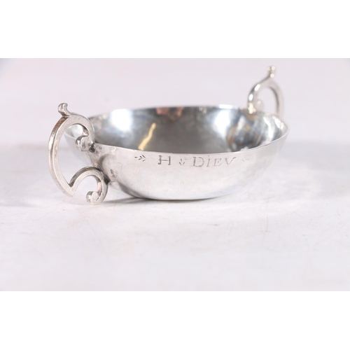 53 - Antique French silver twin handled taste vin, the rim stamped H.Diev, 10cm, 37.7 grams.