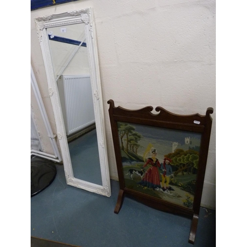 22 - Oak framed tapestry firescreen and a painted wall mirror.