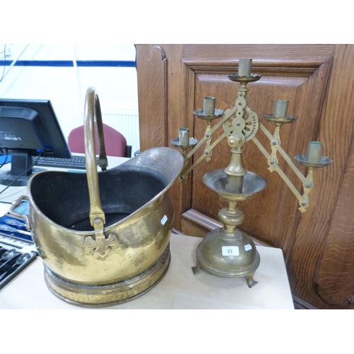 23 - Late Victorian style brass candelabrum and a coal helmet with a swing handle.  (2)
