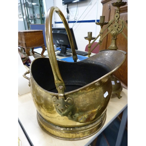 23 - Late Victorian style brass candelabrum and a coal helmet with a swing handle.  (2)