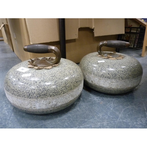 56 - Two curling stones with brass and wood handles.