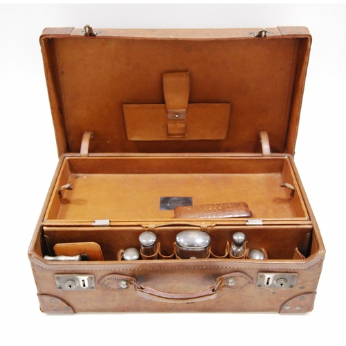 50 - Pigskin dressing case with five silver-mounted glass bottles and other fittings, 1905, inscribed pla... 