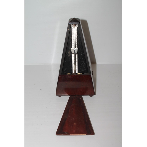 12 - Mahogany cased metronome, 22cm.