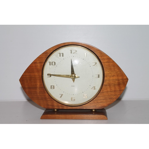 33 - Smiths teak mantel clock of navette form on plinth base, 16cm.