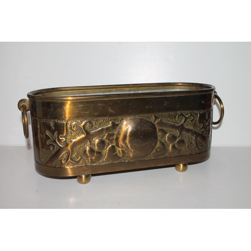 46 - Arts & Crafts style repousse brass twin-handled planter with liner, 42cm.