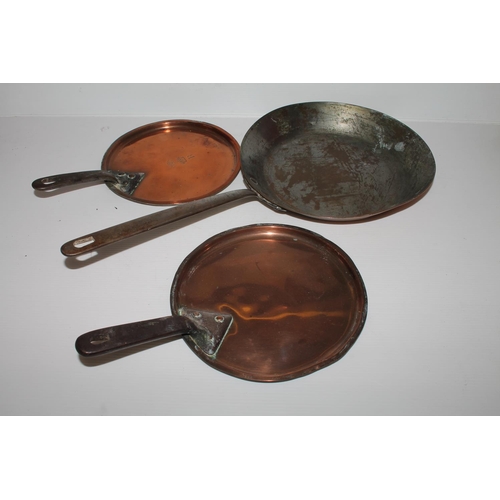 57 - Three copper cooking pans, one stamped W S Adams & Son.