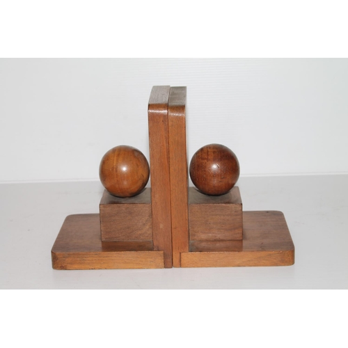 9 - Pair of walnut bookends decorated with sphere on cube, maker LSM of England.