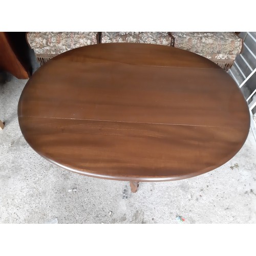 33 - Unusual Ercol drop leaf oval coffee table.