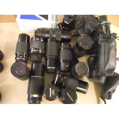 12 - Large amount of some quality camera lenses large and cases various.