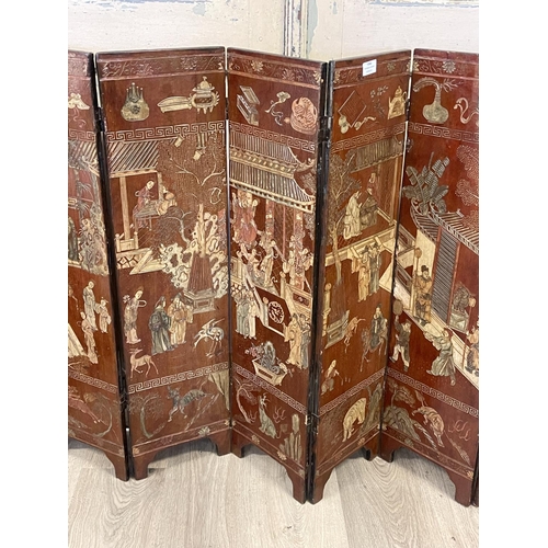 1064 - Chinese eight fold screen, carved and incised decoration, showing various out door scenes, with nobl... 