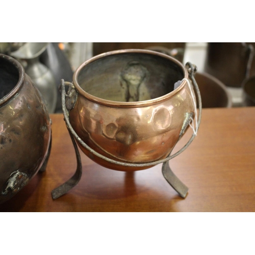 19 - Two antique copper tri-legged pots, approx 22cm Dia and smaller (2)