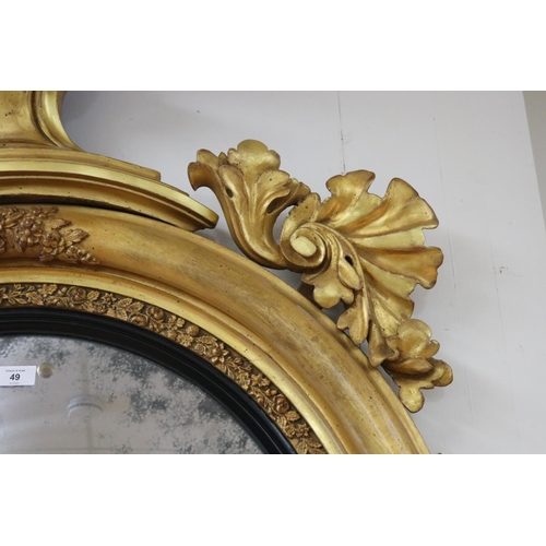 49 - Fine antique Regency giltwood convex circular mirror applied scrolling foliage and crest mounted wit... 