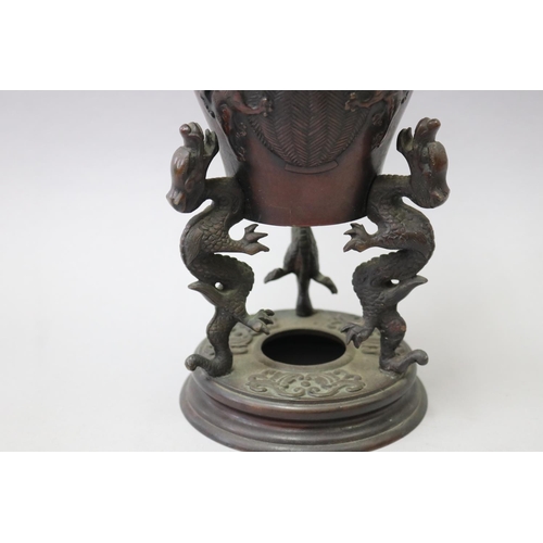57 - Antique Asian bronze incense burner of vase form, with three dragon supports to the base & flared ri... 