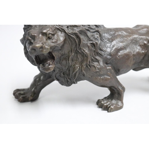 7 - Antique 19th century cast bronze model of a prowling lion, signed 'Rodin' to back leg, approx 32cm L