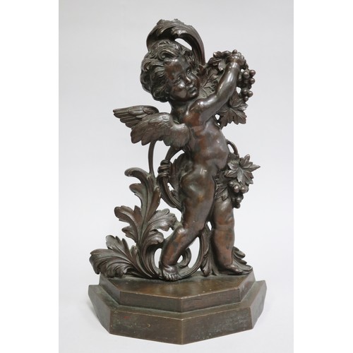 20 - Antique bronze door stop, the figure of a winged putto holding fruiting grape vines, stepped base, l... 