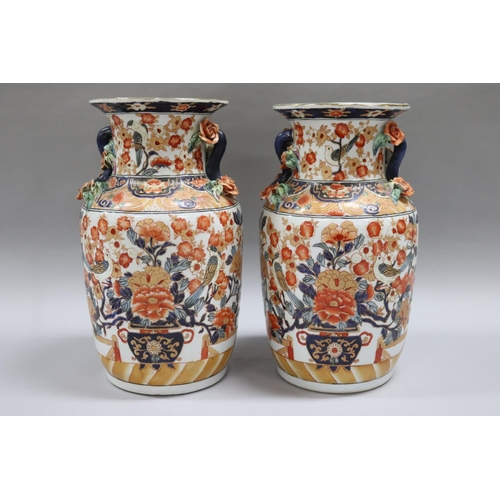 42 - Pair of Chinese Imari pattern vases, each with applied roses and branch form handles. Raised enamel ... 