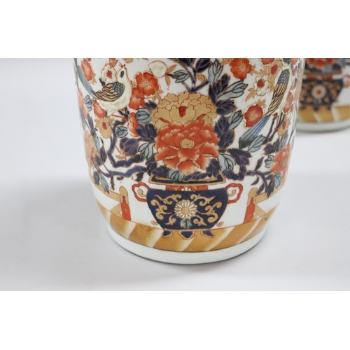 42 - Pair of Chinese Imari pattern vases, each with applied roses and branch form handles. Raised enamel ... 