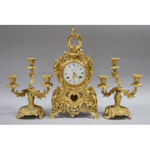 21 - Vintage French brass mantle clock and garnitures, German movement, unknown working condition, has ke... 