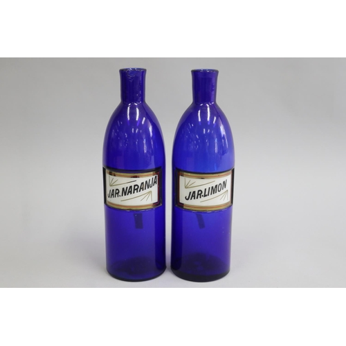 3042 - Pair of antique Bristol blue glass bottles, JAR. LIMON and JAR. NARANJA, each approx 28cm H (2)