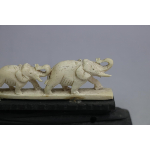 3126 - A chain of elephants sculpture, approx 5cm H x 16cm W
