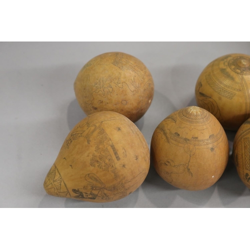 19 - Nine various antique Chinese scrimshawed seed pods with incised decoration of warriors etc. (9)