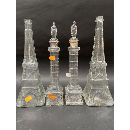 89 - Vintage French glass Decanters, two Eiffel towers, two Trajan columns, approx 35cm H and shorter (4)