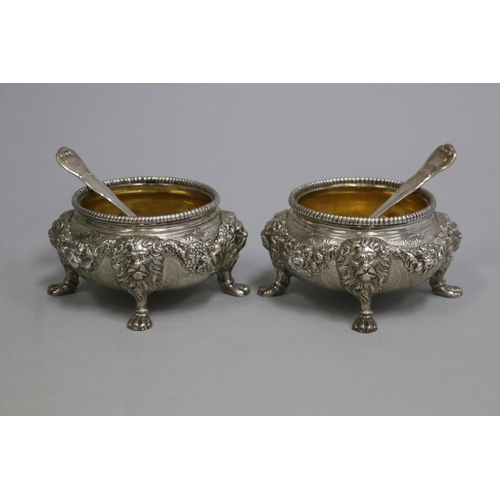 Pair of heavy large antique sterling silver footed salts, with gilt washed interiors. Cast in high relief with lions masks joined by draped floral swags. Both marked for London 1851. By WM (weight, along with a pair of antique sterling silver salt spoons). Marked for London William Chawner 1828, total approx weight 705 grams, each approx 6cm H x 11cm Dia (4)