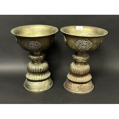 1009 - Pair of large Sino Tibetan metal pedestal fat offering bowls applied pierced decoration, approx 34cm... 