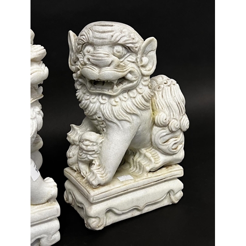 1012 - Pair of Chinese carved white marble dogs of Fo, approx 31cm x 11cm x 18cm  (2)