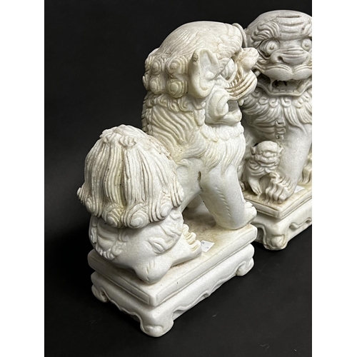 1012 - Pair of Chinese carved white marble dogs of Fo, approx 31cm x 11cm x 18cm  (2)