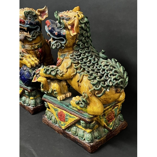 1016 - Pair of polychrome Chinese pottery dogs of Fo, approx 47.5cm H x 33cm W and smaller (2)