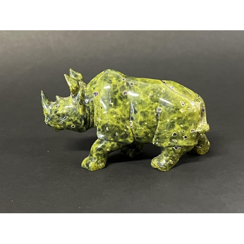 1017 - Carved mottled Green stone rhino, approx 8cm H x 14cm L