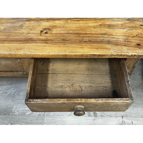 1034 - Antique rustic pine three drawer dresser, with shaped pot board base, standing on turned legs, appro... 