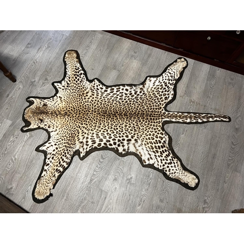 1052 - Antique leopard skin rug, Purchased in the 1920's, approx 210cm H x 104cm W