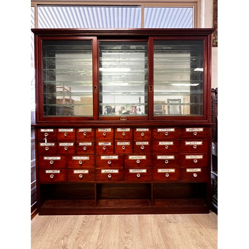 1049 - Antique Chemist shop two height shop cabinet. The Base fitted with 28 named various size drawers, an... 