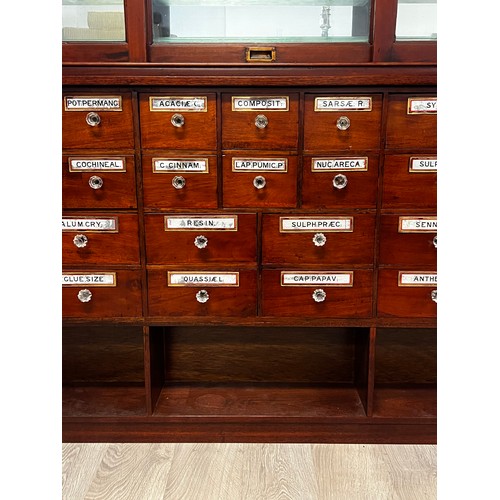 1049 - Antique Chemist shop two height shop cabinet. The Base fitted with 28 named various size drawers, an... 